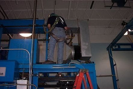 A man standing on top of a blue platform.