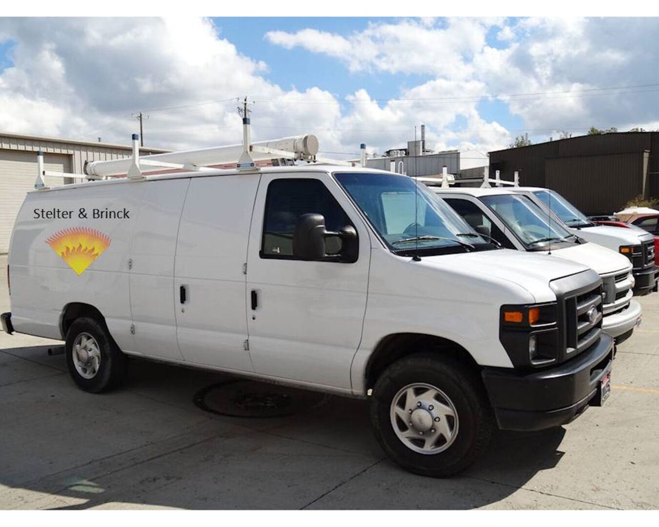 A white van parked in front of some buildings.