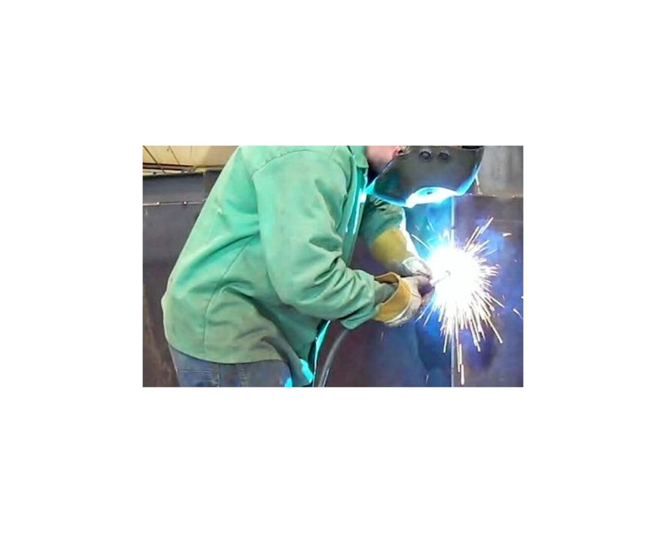 A person welding with a bright light