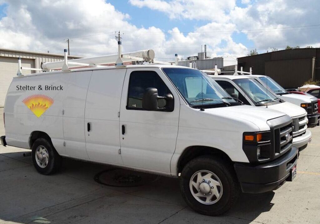 A white van parked in front of some buildings.