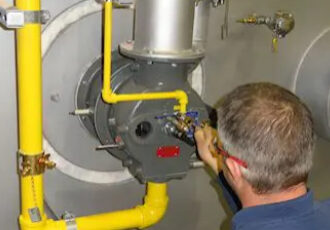 A man working on the inside of an industrial machine.