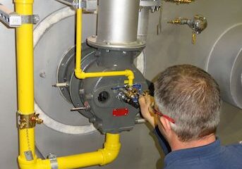 A man working on the inside of an industrial machine.