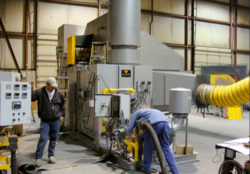 Two men working in a large machine shop.